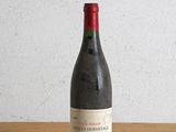 une bouteille de vin posée sur une table devant un mur
