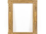 a gold picture frame on a white wall with a white background