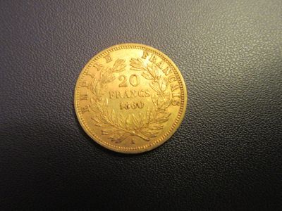 a gold coin sitting on top of a black surface