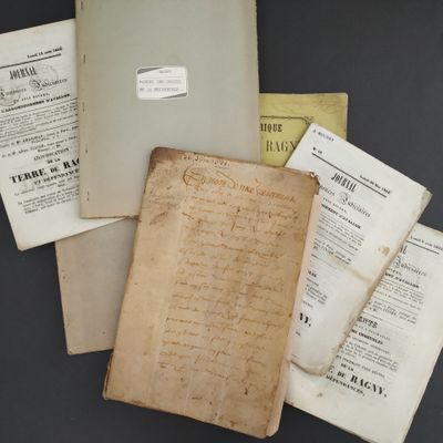 an old book with a lot of papers on top of it