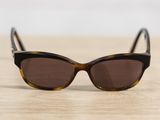 a close up of a pair of sunglasses on a wooden surface