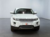 the white range rover is parked in a room with a black floor