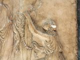 a relief of a man holding a sword and a woman standing next to him