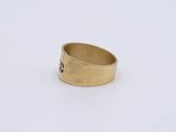 an image of a gold ring on a white surface