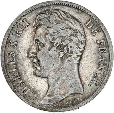 gros plan d'une pièce de monnaie sur laquelle figure un visage de femme