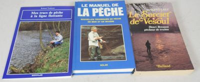 three books on a white table with a man and a dog
