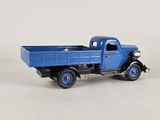 a toy truck that is blue and has red wheels