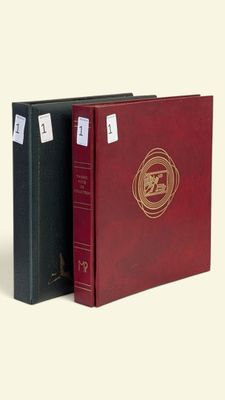 two red and black binders with a gold seal on them
