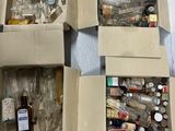 four boxes filled with bottles and bottles sitting on top of a table