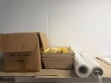 a box of rolls of paper sitting on a table next to a box of rolls of tape