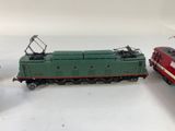 three toy trains sitting next to each other on a white surface