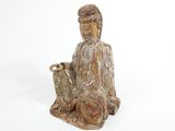 statue of a person sitting on the ground with a dog
