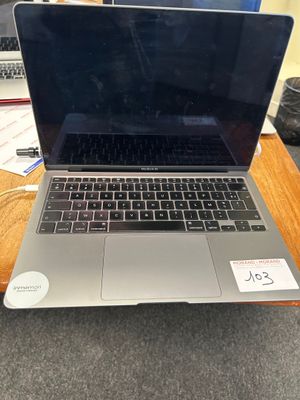 a laptop computer sitting on top of a wooden table