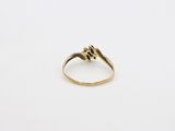 a close up of a gold ring on a white surface
