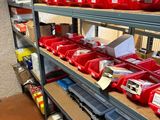 many red bins on the shelves in the warehouse