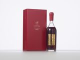 a bottle of wine sitting next to a red box