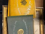 several books are stacked on top of each other on a table
