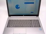 a laptop computer that is open on a white table