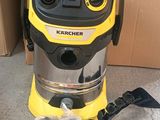 a yellow and black vacuum cleaner sitting on top of a cardboard box