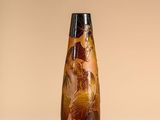 a vase that has a brown and black design on it