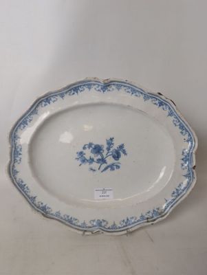 blue and white plate with flowers on it on a white surface