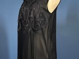 a black leather top with a floral design on the shoulders