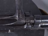 an old machine gun that is sitting on top of a table