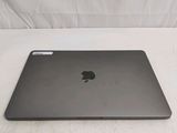 a black apple laptop sitting on a white surface