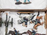 a box with a bunch of toy soldiers in it