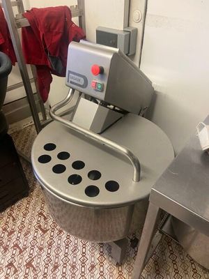 a machine that is sitting in a kitchen next to a sink