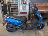 a scooter that is parked in a garage