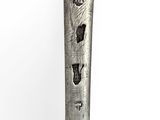 a silver spoon with a design on it on a white surface