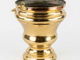 an image of a gold metal vase with a handle on a white background