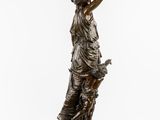 a bronze statue of a woman holding a child