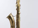 an old brass saxophone with a white background