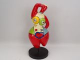 figurine of a man with a red hat and a green shirt