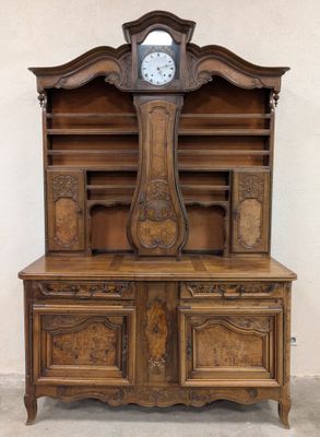 a large wooden cabinet with a clock on top of it