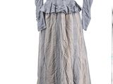 a dress on a mannequin stand in front of a window