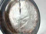 a silver plate with a silver handle on a white table