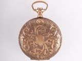 an antique gold pocket watch on a white background with a white background