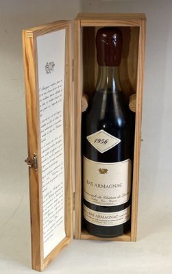 a bottle of wine in a wooden box on a table