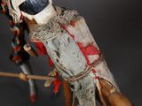 a close up of a voodoo doll with a knife in it