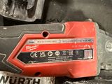 a red tool that is sitting on top of a pile of tools