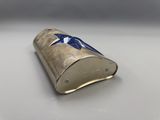 a close up of a silver cigarette case with a blue star on it