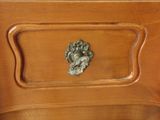 a wooden dresser with a metal handle on it