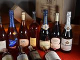 many bottles of wine sitting on a table next to a box of wine