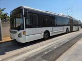 a white bus that is parked on the side of the road