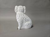 a white dog figurine sitting on a gray surface