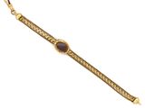 a gold bracelet with a purple stone on a chain
