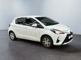 the toyota yaris is parked in a white room with a black floor